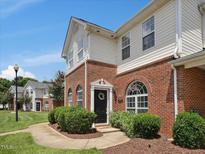 Charming townhome with a welcoming front entrance, well-maintained landscaping, and brick facade at 2021 Rivergate Rd # 102, Raleigh, NC 27614