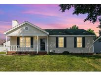 Charming single-story home with a front porch, green lawn, and freshly painted exterior at 2108 Carthage Cir, Raleigh, NC 27604