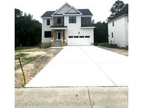 Two-story home features a wide driveway leading to an attached two-car garage at 2651 Bowden Dr, Creedmoor, NC 27522