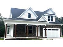 Charming exterior of a new two-story home with stone accents and a covered front porch at 2661 Bowden Dr, Creedmoor, NC 27522
