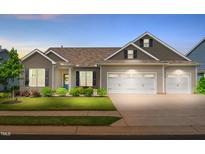 Charming single-Gathering home featuring a two-car garage, tidy landscaping and a welcoming, covered entryway at 3333 Jones Lake Rd, Fuquay Varina, NC 27526
