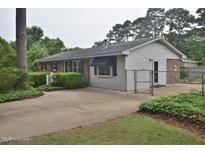 Charming single-story home with a brick and siding exterior, mature landscaping, and spacious driveway at 3610 Lambert Ln, Rocky Mount, NC 27804