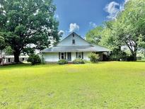 Traditional farmhouse featuring a large, well-maintained yard, and classic architectural details at 747 Buckhorn Rd, Sanford, NC 27330