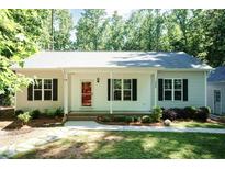 Charming single-story home featuring a welcoming front porch, well-maintained lawn and mature trees at 1006 Oxford Ridge Rd, Wake Forest, NC 27587