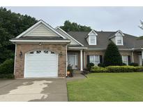 Charming brick home with a well-manicured lawn, attached garage and lovely landscaping at 108 Calloway Road Rd, Rocky Mount, NC 27804