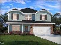 Charming two-story home showcases a brick-accented facade, attached garage, and well-manicured lawn at 1142 Winding Spring Dr, Mebane, NC 27302