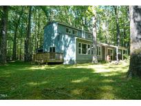 Quaint two-story home nestled among mature trees on a sunny lot at 1423 Alderman Cir, Raleigh, NC 27603