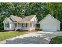 Charming one-story home features a welcoming front porch and a well-manicured lawn at 1749 Conners Ct, Burlington, NC 27215