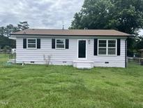 Charming single-story home with light siding, dark shutters and a well-maintained front lawn at 1851 S Clearview Dr, Henderson, NC 27536