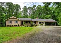 Charming ranch-style home featuring a welcoming front porch, carport, and lovely landscaped front yard at 224 Oakcrest Dr, Wake Forest, NC 27587
