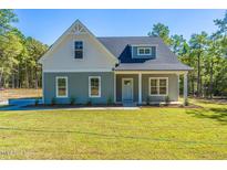 Charming single-Gathering home with a covered front porch and well-manicured lawn at 355 Shaw Rd, Cameron, NC 28326
