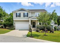 Charming two-story home with a well-maintained lawn, attached garage, and welcoming front porch at 409 Kilcornac Ct, Fuquay Varina, NC 27526