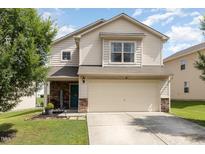Charming two-story home features a two-car garage and manicured lawn at 4401 Lyman Ave, Raleigh, NC 27616