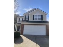 Charming two-story home with a red brick accent and a two-car garage at 4721 Mocha Ln, Raleigh, NC 27616