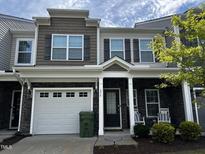 Charming townhome with a mix of stone and siding, covered front porch, and an attached one car garage at 656 Barneswyck Dr, Fuquay Varina, NC 27526