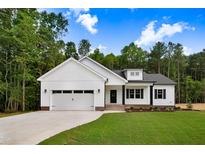 Charming new construction home with a two-car garage, manicured lawn, and beautiful curb appeal at 80 Birchtop Cir, Zebulon, NC 27597