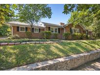 Charming single-story brick home featuring well-maintained landscaping and classic design elements at 800 Camden Ave, Durham, NC 27701