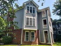 Charming multi-story home with gray siding, red brick accents, and multiple windows at 911 Washington St # 102, Raleigh, NC 27605