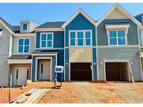 New construction townhomes featuring colorful siding, modern windows, and attached garages at 95 Ripple Way # 212, Clayton, NC 27520