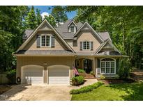 Charming two-story home with a manicured front yard and a two car garage at 100 Donald Dr, Pittsboro, NC 27312