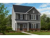 Charming two-story home with gray siding, black shutters, and a brick foundation at 1061 Hardin Hill Ln, Knightdale, NC 27545