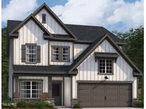 Charming two-story home features board and batten siding, gray trim, and an attached two-car garage at 1413 Malcus Ct # 61, Fuquay Varina, NC 27526