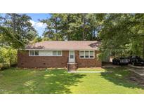 Charming one-story brick house with a manicured lawn and a convenient covered carport at 1832 Blandwood Dr, Rocky Mount, NC 27801