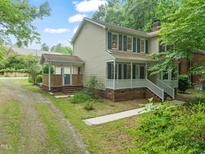 Charming two-story home with a welcoming front porch and beautiful green shutters at 20 Timberlyne Rd, Chapel Hill, NC 27514