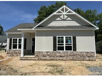 Charming single-Gathering home featuring stone accents, dark shutters, and an inviting covered entrance at 202 S Pearl St, Princeton, NC 27569