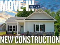 New construction home with stone accents, beautiful landscaping, and charming curb appeal at 202 S Pearl St, Princeton, NC 27569