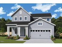 Charming two-story home with gray siding, black roof, an attached two car garage and a welcoming front porch at 25 Cozy Hvn, Fuquay Varina, NC 27526