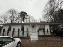 Charming single-story home with painted brick foundation and well-manicured landscaping at 6908 Park Pl, Raleigh, NC 27616