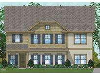 Charming two-story home with gray shingles, symmetrical design, blue shutters and a manicured front yard at 70 Guardian St, Youngsville, NC 27596