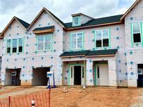 Townhome exterior under construction with visible framework and Mungo Homes wrap at 99 Ripple Way # 211, Clayton, NC 27520