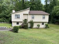 Traditional two-story home with siding, well maintained front lawn and mature landscaping at 10 Winchester Ct, Durham, NC 27707