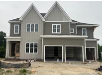 Two story home with a three car garage and large windows at 1025 Azalea Garden Cir, Raleigh, NC 27603