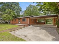 Brick ranch-style home with a covered carport and a spacious front yard, offering classic charm and functionality at 1051 Old Us 421, Lillington, NC 27546