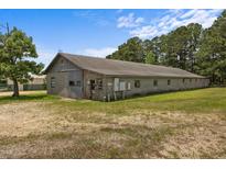 Exterior of building featuring a weathered facade, number address, and tree on lot at 1085 Old Us 421, Lillington, NC 27546