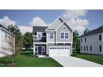 Charming two-story home features a two-car garage, neutral siding, and a well-manicured lawn at 1107 Westerland Way # 29, Durham, NC 27703