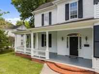 Charming front porch with white columns and black shutters enhances this home's curb appeal at 112 Rectory St, Oxford, NC 27565