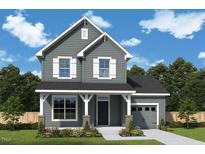 Charming two-story home boasts beautiful gray siding, white trim, and a covered front porch at 121 Restful Point, Fuquay Varina, NC 27526
