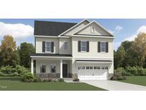 Charming two-story home with white siding, black shutters, and stone accents on the facade and garage at 1240 Hazelnut Ridge Ln, Knightdale, NC 27545