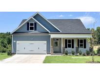 Charming two-story home featuring a two-car garage, attractive color scheme and inviting front porch at 131 Fish Camp Dr, Wendell, NC 27591