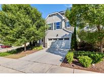 Charming two-story home with a two-car garage, complemented by lush landscaping and a concrete driveway at 226 Begen St, Morrisville, NC 27560
