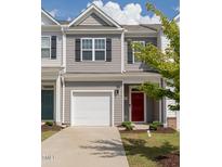 Charming townhome with a one-car garage, gray siding, and a vibrant red front door at 227 Liam St, Clayton, NC 27520