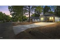 Charming home featuring a long driveway and well-maintained landscaping at 2305 Pinecroft Dv, Burlington, NC 27217
