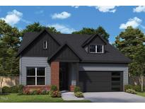 Charming single-Gathering home showcasing a modern design with brick accents and a well-manicured lawn at 287 Aspen Ave, Pittsboro, NC 27312