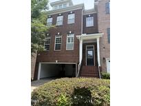 Two story brick home with a garage entrance and front door entryway at 3041 Weston Green Loop, Cary, NC 27513