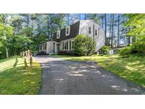 Charming home exterior features a long driveway and traditional architectural details surrounded by mature trees at 3070 Cameron Dr, Henderson, NC 27536