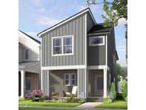 Charming new construction home with vertical siding, covered front porch, and manicured lawn in a friendly neighborhood at 338 Cottage Hill Way, Knightdale, NC 27604